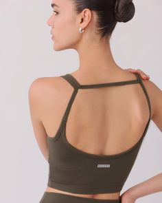 The SARA TOP in ASH is made with Nylora's signature 4-way stretch rib fabric, providing both comfort and style. The open back detail adds a touch of unique design, while the built-in shelf bra with removable padding offers support and versatility. Perfect for any active lifestyle. DETAILS: Open back detail top Nylora's signature 4-way stretch rib fabric Built-in shelf bra with removable padding 77% Nylon, 23% Spandex Machine wash SIZE & FIT: Fits true to size Length: 10" Bust: 14 1/4" Bottom: 12 High Stretch Sports Tops With Removable Bra Pads, Athleisure Tops With Removable Bra Pads And Compressive Fit, Fitted Athleisure Crop Top With Removable Bra Pads, Fitted Racerback Activewear With Removable Bra Pads, Compressive Athleisure Tops With Removable Bra Pads, High Stretch Racerback Activewear With Removable Bra Pads, High Stretch Bra Friendly Activewear With Tank Straps, Fitted Sports Bra With Built-in Support, Fitted Sports Bra With Built-in Bra