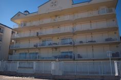 an apartment building with balconies on the second floor