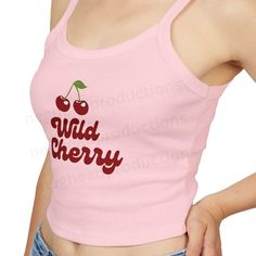 Add a pop of fun to your wardrobe with our fitted Wild Cherry Tank Top! This adorable top features a playful design with two cute cherries, making it a perfect addition to your wardrobe. This micro rib tank top features thick spaghetti straps and rests just above the belly button. It pairs effortlessly with your favorite jeans, shorts, or skirts. Available colors: ~Baby Blue ~Pink ~White Please see the detailed size chart to help you choose the right size. Fabric blend features 52% Airlume combe Y2k Style Cotton Tops With Cherry Print, Red Cotton Tank Top With Letter Print, Cute Strawberry Print Tops For Spring, Red Strawberry Print Top For Summer, Red Letter Print Tank Top For Spring, Cute Sleeveless Strawberry Print Top, Cute Sleeveless Top With Strawberry Print, Fitted Summer Tops With Slogan, Trendy Red Tank Top With Letter Print