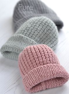 three knitted hats laying on top of each other