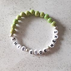 "A pretty beaded breastfeeding reminder bracelet. The bracelet consists of pale green acrylic beads. The coloured beads are known as miracle beads which are a type of resin bead with a lacquered surface which makes them incredibly shiny. They almost look like a bead within a bead. The beads measure approximately 8 mm. The bracelet measures 7 inches but as it is made from elastic it will stretch to accommodate most wrist sizes. There are silver plated spacer beads between the lettering. The wording on the bracelet reads \"This Side Next\". If you forget which side your baby has last fed from this bracelet can help. As it is a stretch bracelet made from elastic it is easy to swap form one wrist to the other, simply roll down over your wrist to avoid overstretching the bracelet. You bracelet Gifts For Mom To Be, Baby Shower Gifts For Mom, Mom To Be, New Mom Gift, Green Jewelry, Bracelet Ideas, Black Gift Boxes, Minimalist Bracelet, Resin Beads