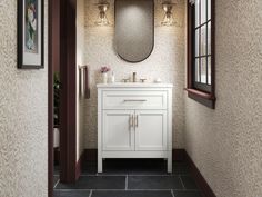 a white sink sitting under a mirror next to a wall mounted faucet in a bathroom