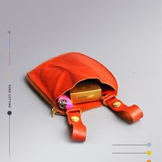 an orange purse sitting on top of a table