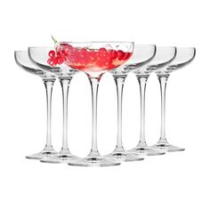 four wine glasses with cherries in them