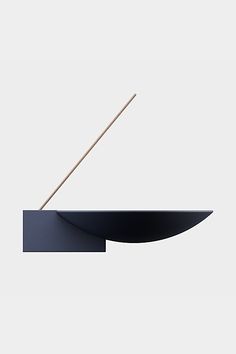 a black object with a wooden stick sticking out of it's centerpieces