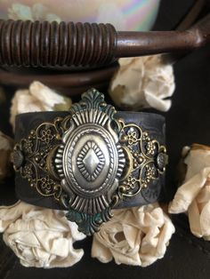 "Country leather bracelet cuff, western jewelry Distressed black embossed genuine leather 1 1/2\" strap has been adorned with an oval southwestern silver concho which sets on a detailed antiqued bronze filigree which has been given a rich patina attached to the leather with two textured gunmetal rivets. One gunmetal snap has been placed to fit up to a 7\" wrist. I can add another snap for a smaller or larger wrist size but you need to convo me before purchasing The last photos feature other item Cowgirl Bracelets, Western Bling, Cowgirl Gifts, Chunky Bracelet, Horse Jewelry, Santa Clarita, Chunky Bracelets, Bracelet Leather, Western Leather