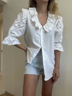 A lovely vibtagw white cotton blouse with a crochwt emroidery. Absolutely amazing quality and attention to detail! Size XS-M Our model is a size Xs -S and the top is not pinned on her. Mint condition, deadstock vintage item. Looks amazing in person! Spring Cotton Lace Blouse With Broderie Anglaise, Broderie Anglaise Cotton Lace Top, Spring Blouse With Lace Collar, Spring Cotton Lace Blouse With Lace Collar, Cottagecore Short Sleeve Top With Lace Collar, White Broderie Anglaise Lace Top With Short Sleeves, Summer Lace Blouse In Cottagecore Style, Spring Cotton Lace Top With Lace Collar, Spring Cotton Blouse With Crochet Trim