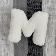 the neck pillow has been made from sheep's wool and is attached to a black tie