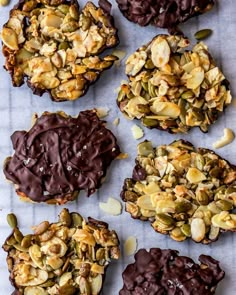 several cookies with chocolate frosting and nuts on top