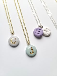 three different necklaces with the letter j on them