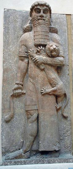 an ancient statue with a man holding a cat