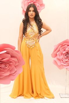 Yellow corset style blouse with thread embroidered floral motifs, embellished by sequins, pearls and tassels. Comes with sharara. - Aza Fashions Sleeveless Georgette Set With Unstitched Blouse, Festive Sleeveless Yellow Palazzo Set, Festive Yellow Sleeveless Palazzo Set, Sleeveless Sets With Dori Work For Navratri, Yellow Sleeveless Set For Eid, Sleeveless Dori Work Sets For Eid, Pearl Corset, Sharara For Women, Yellow Corset