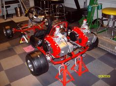 an image of a car being worked on in a garage or workshop with tools and equipment