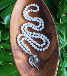 "☾ This mala necklace is created with natural, ethically-sourced Gemstones:  SELENITE  Clearing, Cleansing, Inner Peace, Calmness of Mind, Release of the Old, and New Beginnings ✸ Natural Selenite (Grade AA) 8mm beads ✸ Vintage rhodium plated brass Buddhist Prosperity Turtle Amulet, Made in Thailand, Blessed in Bhutan ✸ Sterling Silver & Vintage Rhodium plated brass beaded details This mala features 108 beads, hand-knotted in traditional style between each bead. The beads are each 8mm in diamete Spiritual Moonstone Crystal Necklace With Gemstone Beads, Spiritual Moonstone Beaded Necklace With Natural Stones, White Amulet Jewelry For Meditation, White Hand-strung Amulet Necklace, White Crystal Necklaces With Gemstone Beads For Healing, White 8mm Beads Spiritual Crystal Necklaces, White 8mm Beads Spiritual Crystal Necklace, Spiritual Beaded Pearl White Necklace, White Spiritual Necklace With Polished Beads