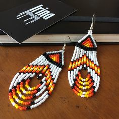 #irinahaluschak #indianearrings #indianjewelry #earrings #beadedearrings #seedbeadearrings #tribalearrings #tribaljewelry #boho #bihemian #bohojewelry #etsy #etsyshop #shopetsy #etsyjewelry #etsyearrings #nativeamerican #nativeearrings #nativeamericanjewelry #whitebeadedearrings #chandelierearrings #fringeearrings #dangleearrings #tasselearrings #fireearrings #fire #redesrrings #orangeearrings #yellowearrings #giftforher Traditional Polished Beaded Earrings For Gifts, Traditional Large Bead Drop Earrings, Artisan Beaded Drop Earrings With Large Beads, Teardrop Beaded Earrings With Large Beads For Festivals, Traditional Teardrop Beaded Earrings With Tiny Beads, Traditional Large Beaded Drop Earrings, Artisan Large Beads Drop Earrings, Teardrop Large Beaded Earrings For Festivals, Traditional Teardrop Earrings With Tiny Beads