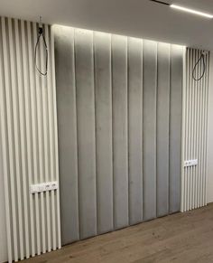 an empty room with vertical blinds on the wall