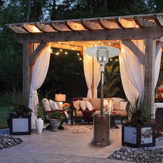 a gazebo with lights on it in the evening