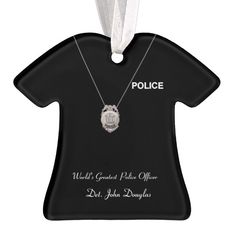 a police ornament hanging from a white ribbon on a black t - shirt