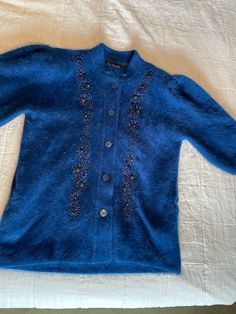 Absolutely gorgeous bright blue embellished with beads rabbit angora hair and acrylic and nylon coat / jacket. Buttons in the front. XL one size. Great condition! Vintage Blue Outerwear For Party, Elegant Embellished Blue Outerwear, Blue Embellished Party Outerwear, Elegant Blue Embellished Outerwear, Blue Embroidered Outerwear For Party, Party Embroidered Blue Outerwear, Party Blue Embroidered Outerwear, Blue Embroidered Party Outerwear, Elegant Blue Embroidered Outerwear