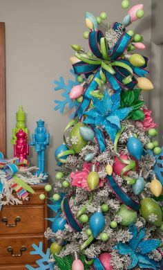 a decorated christmas tree with blue and green decorations