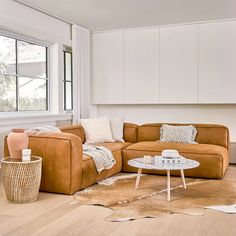 a living room with two couches and a coffee table in front of a window