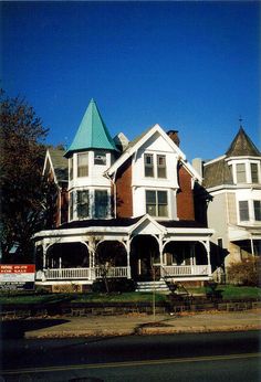 a large white house with many windows on the front and side of it's roof