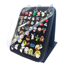 a black case with lots of different pins and scissors on the front, attached to it