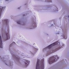 some ice cubes are sitting on top of each other in a white bowl filled with water