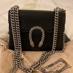 Excellent Condition, Black And Swarovski Crystals. Grained Leather, Very Durable. Paid $2600 Plus 10% Tax. Comes With Gucci Dust Bag. Silver Gucci Bag With Chain Strap, Gucci Bag With Silver-tone Hardware For Party, Chic Formal Shoulder Bag With Silver-tone Logo Plaque, Gucci Party Bag With Silver-tone Hardware, Gucci Silver Shoulder Bag With Silver-tone Hardware, Chic Evening Bag With Silver-tone Logo Plaque, Luxury Formal Shoulder Bag With Silver-tone Logo Plaque, Designer Silver Shoulder Bag Gift, Designer Silver Shoulder Bag As Gift