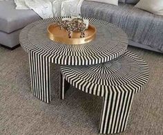 three tables with black and white stripes on them in front of a couch, coffee table