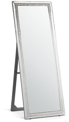 a large mirror sitting on top of a wooden stand with a metal frame around it