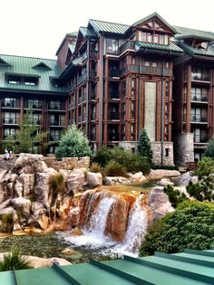 a large building with a waterfall in front of it