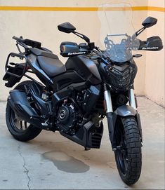 a black motorcycle parked in front of a building