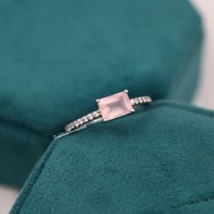 Natural Rose Quartz Emerald Cut Ring, Pink Quartz Engagement Ring, Promise Ring, Crystal Ring, Valentine's Day Jewelry Gift for Couple  ❥ RING DESCRIPTION :- ✦ Handmade, high-quality item! ✦ Material: SOLID 14K/18K/24K GOLD (can be made in white/rose/yellow gold) ✦ Center Stone:  Rose Quartz ✦ Stone Shape: Emerald Shape Facet Cut ✦ Dimensions:- 7 X 5 MM ✦ Color: Pink ✦ Side Stone: Cubic Zirconia  ✦ Color: Transparent ✦ Clarity: Eye Clean  ❥ FINISHES :- ✦ 925 Sterling Silver, 22k Yellow Gold, Rose Gold, White Gold or Black Gold Plating.  ❥ NOTE :-  ✦ Due to the nature of the gemstones, the appearance of each piece may slightly vary in color. ✦ The shades of each Rose Quartz vary since they are natural and untreated. If you have a shade preference, please indicate it in the notes section. ✦ Rose Quartz Wedding Ring, Quartz Wedding Ring, Rose Quartz Wedding, Emerald Cut Ring, Quartz Engagement Ring, Ring Emerald Cut, Ring Crystal, Emerald Cut Rings, Stone Rose