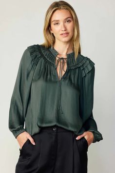 A gathered yoke and layered ruffles at the shoulders heighten the feminine charm of this breezy blouse. It's cut for a loose, relaxed silhouette and features a split neckline, self-tie detailing, and long sleeves with elasticized cuffs.  •Split neckline with self-tie •Gathered yoke •Ruffle trim •Long sleeves with elast Long Sleeve Ruffled Smocked Top For Fall, Long Sleeve Smocked Top With Ruffles For Fall, Chic Flowy Blouse With Split Neck, Chic Flowy Split Neck Blouse, Casual Ruffled Split Neck Blouse, Feminine Long Sleeve Peasant Top With Ruffles, Billowy Long Sleeve Peasant Top With Ruffles, Elegant Long Sleeve Blouse With Gathered Neckline, Chic Billowy Peasant Top With Ruffles