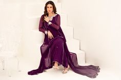 Expertly crafted in a rich plum purple hue, this long Shalwar Kameez features a flattering a-line silhouette. Adorned with intricate mukesh shirt work and a hand-embroidered neckline, this suit exudes elegance and sophistication. Perfect for formal occasions, this piece is sure to make a statement. 3-Piece Suit Traditional Purple Salwar Kameez For Formal Occasions, Festive Purple Salwar Kameez For Formal Occasions, Formal Purple Salwar Kameez For Festive Occasions, Elegant Purple Kurta For Eid, Elegant Purple Churidar For Festive Season, Elegant Purple Churidar For Diwali, Elegant Purple Salwar Kameez With Zari Work, Unstitched Purple Dress With Mirror Work, Purple Anarkali Unstitched Suit For Party