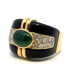 Fabulous emerald, diamond, and onyx cocktail ring handcrafted in 18 karat yellow gold. The band features a bezel set oval cabochon green emerald weighing approximately 4.00 carats, 24 round briliant cut diamonds weighing approximately 2.50 carat total weight, and onyx accent. The diamonds are graded H-I color and SI clarity. The ring measures 19.5mm in width tapering down to 6.5mm, and is currently size 8.5 (can be sized). Weight: 18.4 grams. Luxury Emerald Ring With Oval Cabochon And 17 Jewels, Luxury Oval Cabochon Emerald Ring With 17 Jewels, Fine Jewelry Green Cabochons For Formal Occasions, Green Cabochons For Formal Fine Jewelry, Luxury Oval Cabochon Emerald Ring, Elegant Formal Cabochon Ring, Luxury Green Cabochons, Elegant Cabochon Emerald Ring For Formal Occasions, Elegant Green Cabochons For Formal Occasion