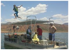 a man jumping into the air from a pontoon while others look on in awe