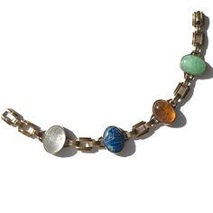 "Vintage gold filled scarab bracelet in the retro style was made by Engel Brothers during the past mid century. Hand carved semi precious stones are  aventurine, citrine quartz, sodalite and clear quartz. The fold over clasp blends nearly invisibly with the gold filled links, creating a seamless look we love. Ancient Hieroglyphs show the interpreted meaning of the scarab is \"to be transformed\".  Perhaps it may be your very own totem of new life and new beginnings? Bracelet length is 7 inches. Ancient Hieroglyphs, Scarab Bracelet, Bracelets With Meaning, The Fold, Semi Precious Stones, Stone Carving, Chain Link Bracelet, 10k Gold, Clear Quartz