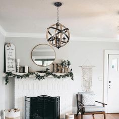 a living room filled with furniture and a fire place in front of a white fireplace