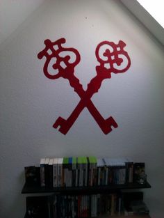 the wall is decorated with red stencils and two crossed keys on each side