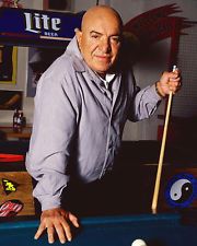 a man leaning over a pool table with a cue in his hand