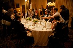 a group of people sitting around a dinner table