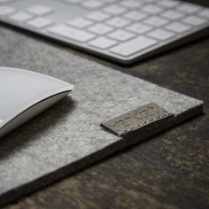 a computer mouse sitting on top of a desk next to a keyboard and mouse pad