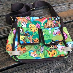 Tokidoki Le Sportsac Foresta Green Purse X Body Stellina Messenger Bag Kawaii Cartoon Rare Nylon Bag. 2 Exterior Flap Pockets. 1 Exterior Zipper Pocket. Rainbow Zipper Closure. 1 Inside Zipper Pocket. Adjustable Strap. Orange Lining. Measurements Are Approximate: Height - 9” (Not Including Strap) Width - 10” Depth - 5” No Stains, Rips, Tears, Or Holes. See Pictures For Additional Details Of Condition. Smoke Free Home. Kawaii Shoulder Bag With Adjustable Strap For Everyday, Harajuku Tote Satchel For Everyday Use, Harajuku Style Tote Satchel For Everyday Use, Harajuku Style Satchel Shoulder Bag For Travel, Harajuku Style Shoulder Satchel For Travel, Kawaii Shoulder Bag For Everyday And Back To School, Cute Multicolor Bags For Daily Use, Cute Multicolor Daily Use Bags, Kawaii Everyday Satchel Shoulder Bag