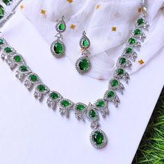 Discover the allure of artisan craftsmanship with this Handmade Emerald Green Crystal Necklace Set. Skillfully crafted with attention to every detail, this set features a stunning silver-plated necklace adorned with vibrant green crystals and matching earrings. Each piece is designed to add a touch of elegance and sophistication to your ensemble, making it perfect for weddings, parties, and special occasions. Materials: Silver-Plated Metal: Handcrafted with premium silver plating, offering both Hand Set Emerald Necklaces For Formal Occasions, Formal Hand Set Emerald Necklaces, Formal Hand Set Emerald Necklace, Formal Hand-set Emerald Necklaces, Cubic Zirconia Necklace For Party, May Birthstone, Formal Bridal Necklace With 17 Jewels And Emerald, Crystal Jewelry For Anniversary, May Birthstone, Fine Jewelry With Stone Setting For Wedding, Formal Cubic Zirconia Necklace For May Birthstone