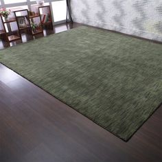 a green rug in the middle of a room