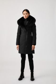 TRISH is a Powder Touch down coat for women with a Signature Collar with silver fox fur and a windproof shell. Water resistant, repellent, and breathable, it is expertly tailored to a fitted silhouette and features a distinctive asymmetrical zip closure for avant-garde styling. Storm cuffs and an inner ribbed bib add extra warmth in extreme weather. A bold style statement with protective comfort. Longline down coat 800 fill power Traceable duck down Arctic Rated: Down to -30°C Breathable and win Parka Jackets, True Winter, Black Down, Down Jackets, Silver Fox, Duck Down, Down Coat, Fox Fur, Bold Fashion