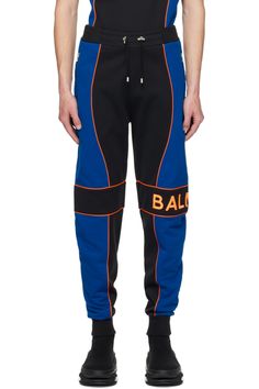 Balmain: Black & Blue Paneled Joggers | SSENSE Sporty Joggers With Logo Waistband For Streetwear, Casual Blue Bottoms With Logo Waistband, Blue Joggers With Elastic Side Panels For Jogging, Michigan Wolverines, French Terry, Piping, Black Blue, Michigan, Blue Black