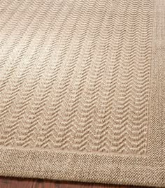 a beige rug with wavy lines on it